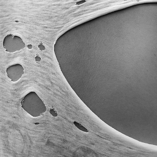 photograph of a woman wearing a torn tee shirt by Alan Ostreicher
