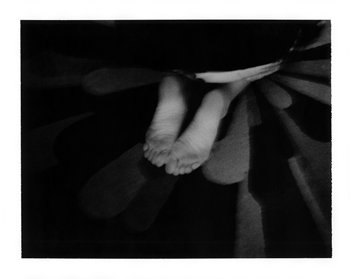 photograph of a woman's feet on an abstract rug by Alan Ostreicher